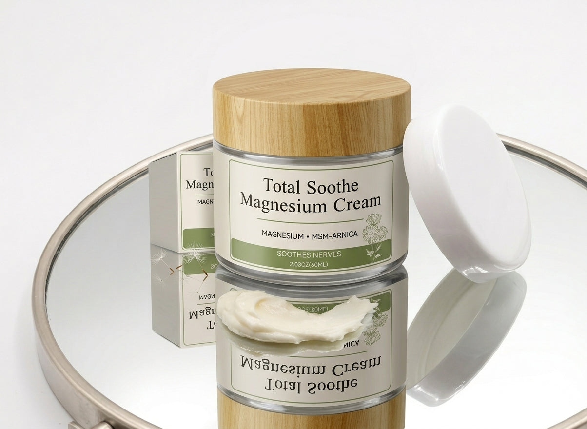 Total Soothe Magnesium Cream jar and box on a mirrored tray with a smear of cream